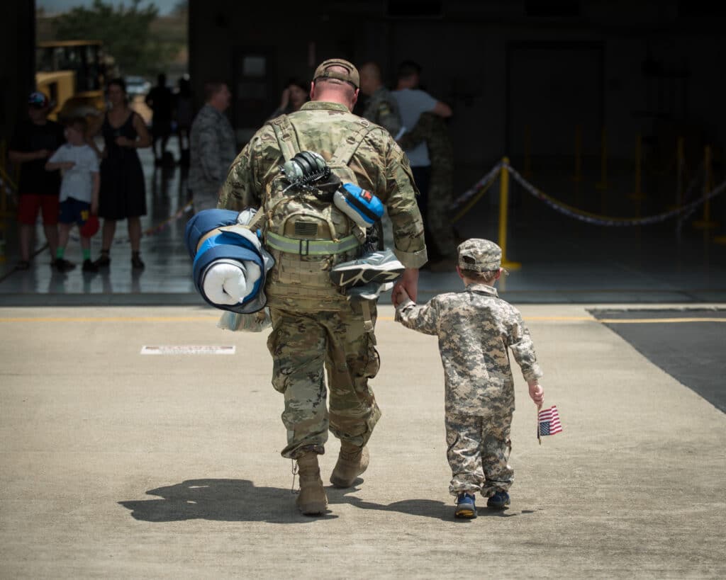 Soldier father and son reunited after deployment.