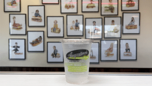 Augustino's Rock & Roll Deli compostable cup on counter