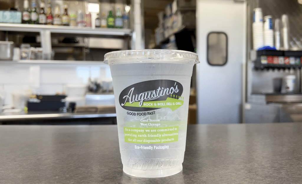Augustino's Rock & Roll Deli compostable cup on counter