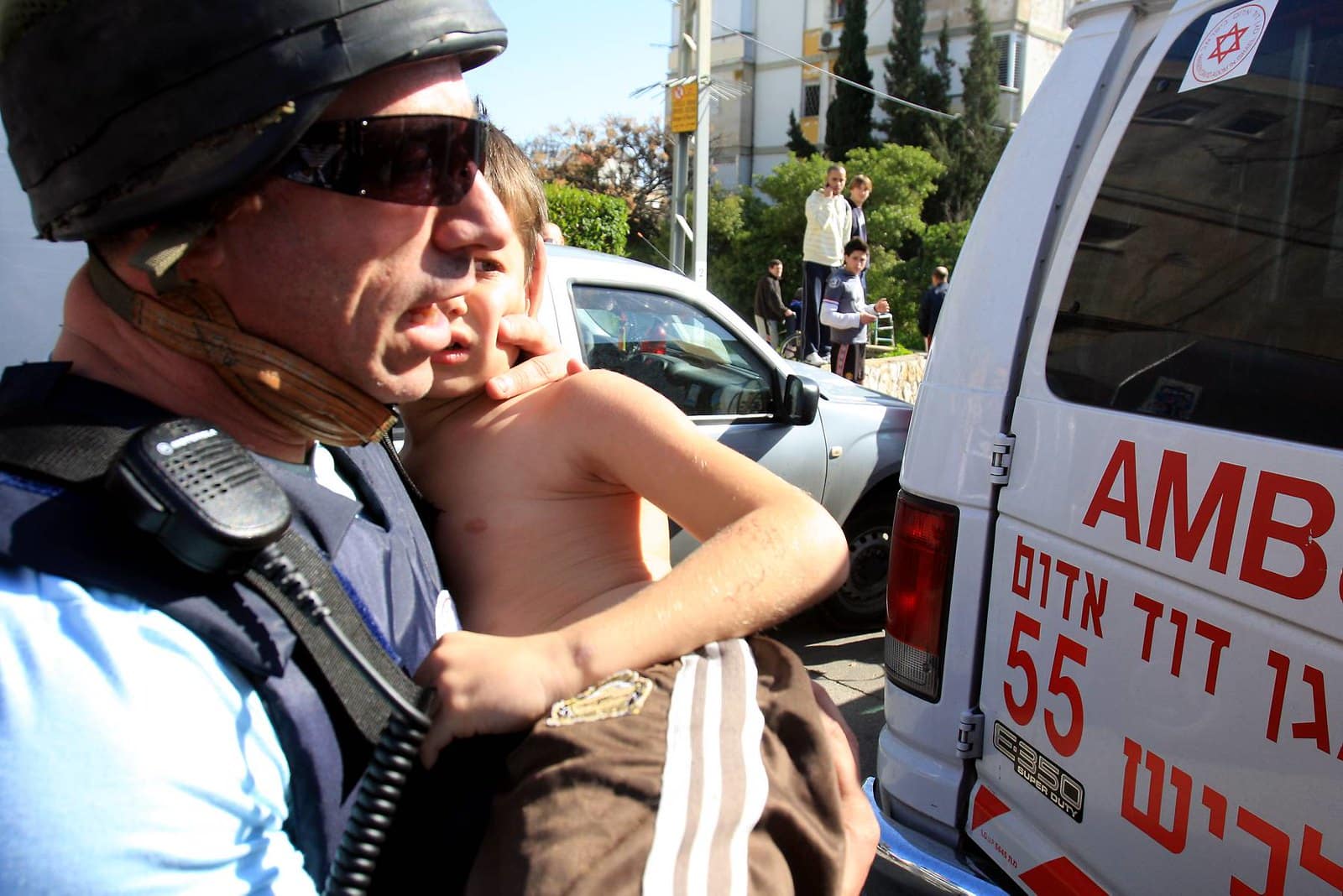 Israel Attack aftermath police officer carrying child