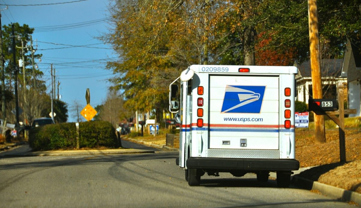USPS truck delivering mail on the side of the road