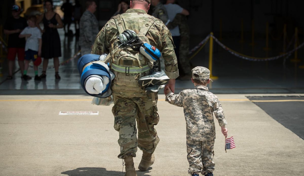 Soldier father and son reunited after deployment.
