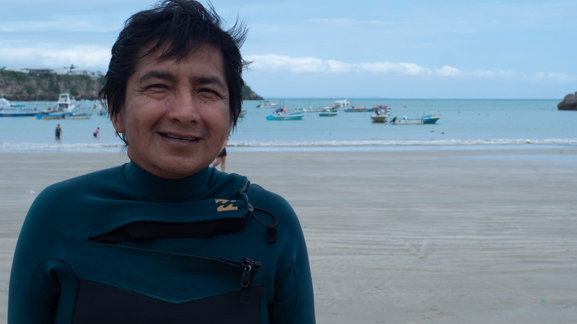 Ambrosio Yagual in a diving suit beside the Pacific Ocean in Ayangue, Ecuador